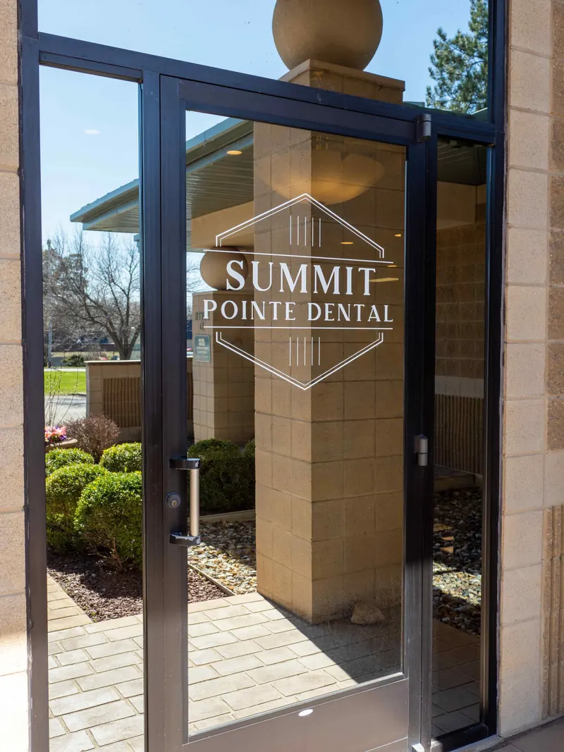 The glass front door with the Summit Pointe Dental logo