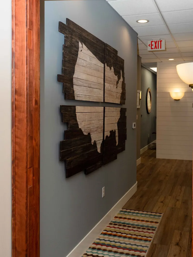 A wooden map of the United States in the hallway