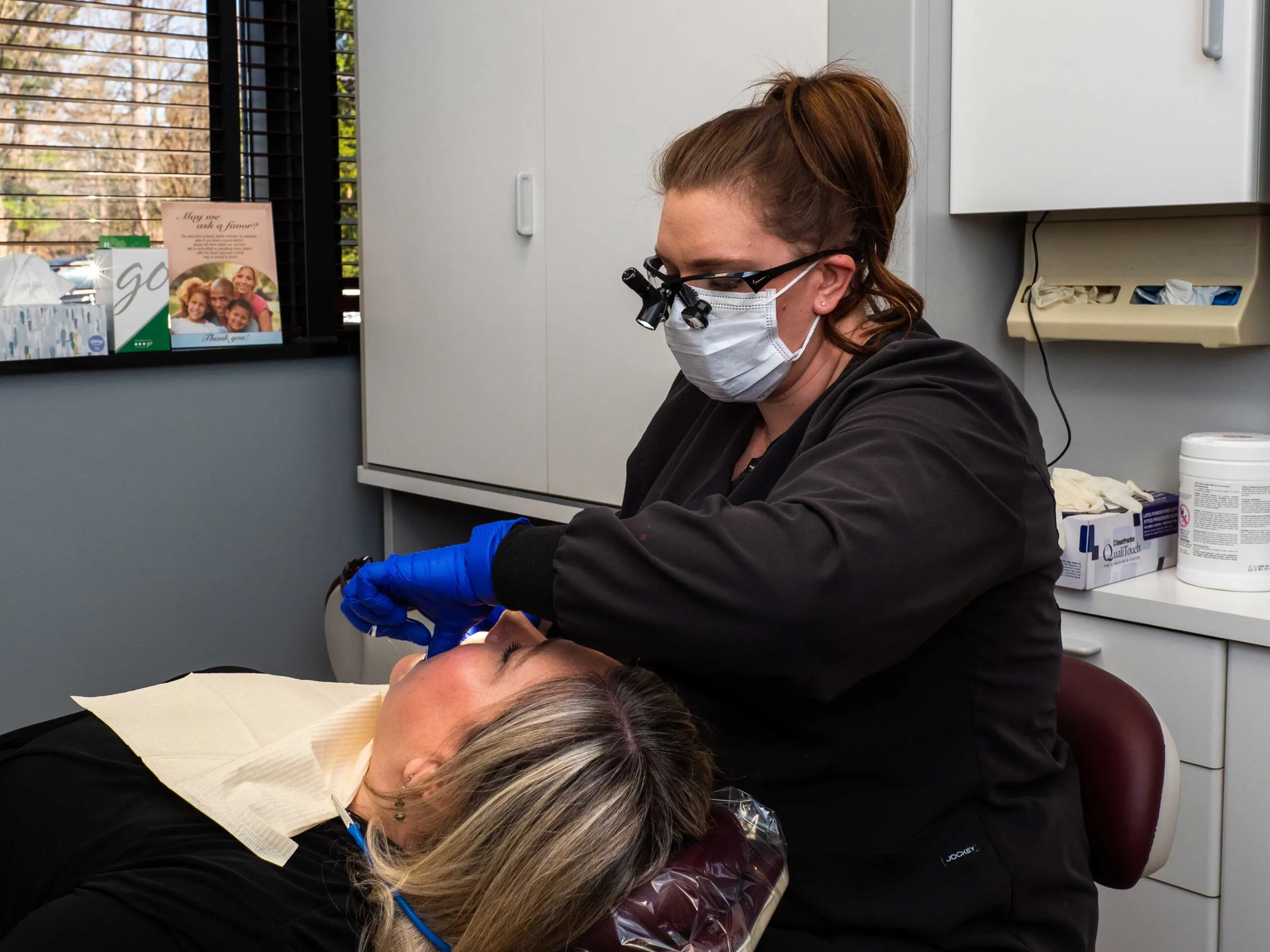 A hygienist at Summit Pointe Dental cleaning a patient's teeth