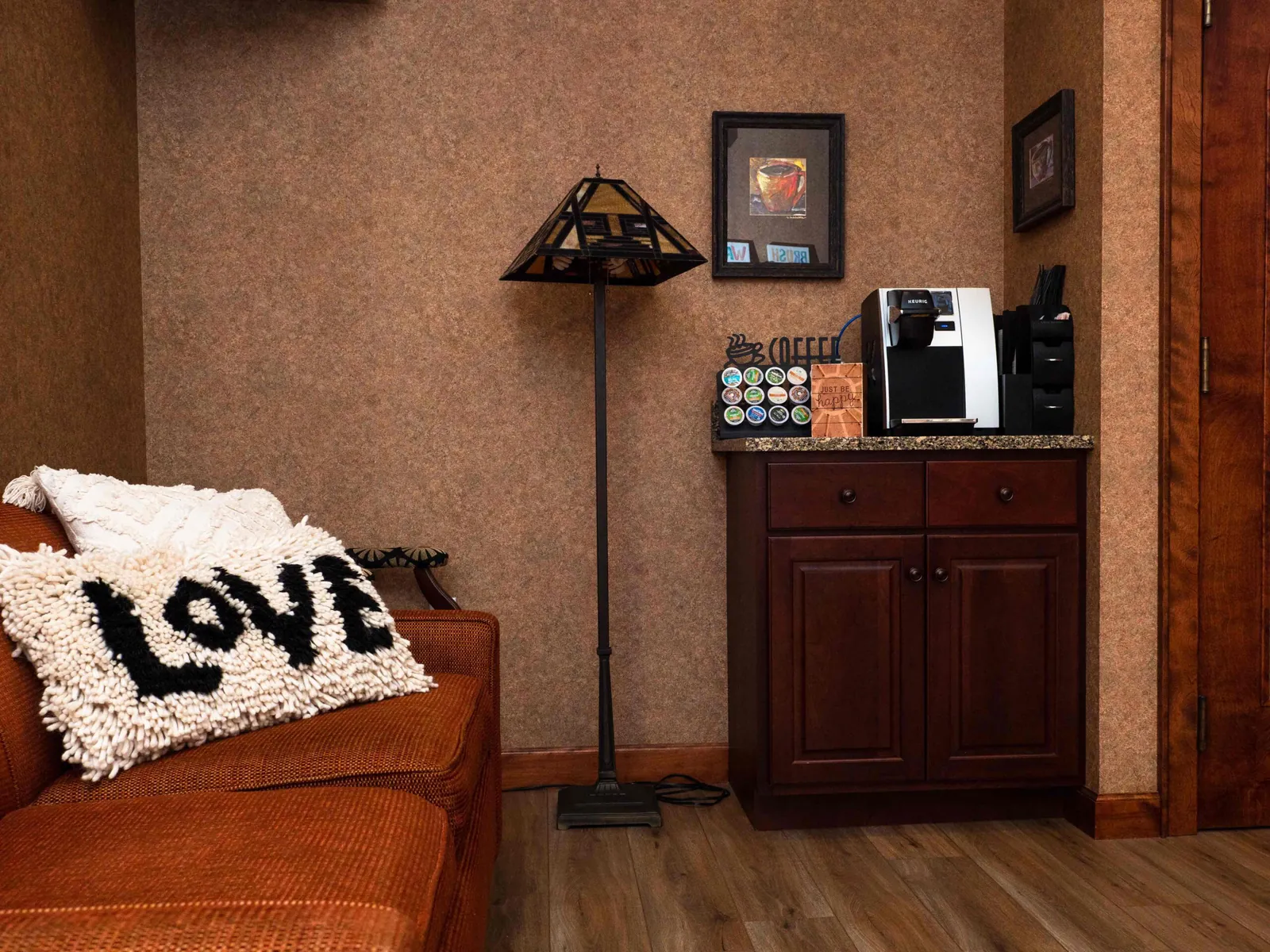 The lounge at Summit Pointe Dental with a Love pillow and a reading lamp