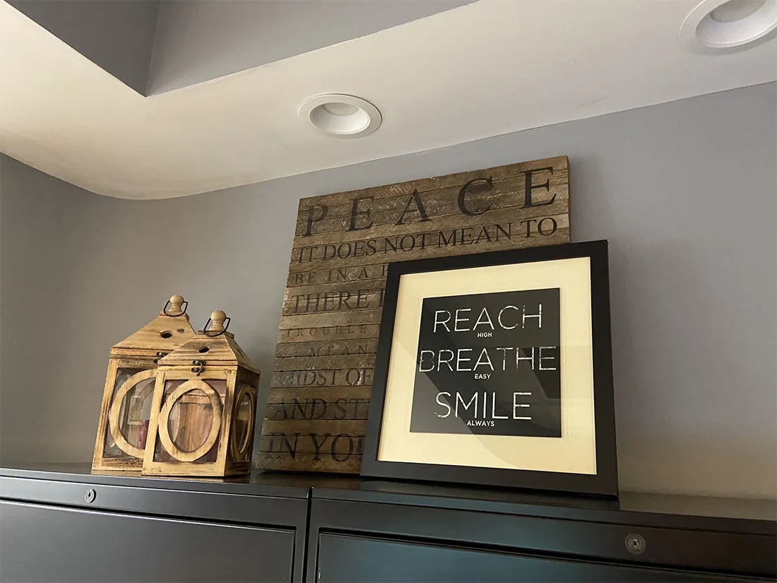 A framed sign reading Reach, Create, Smile in the Summit Pointe Dental office