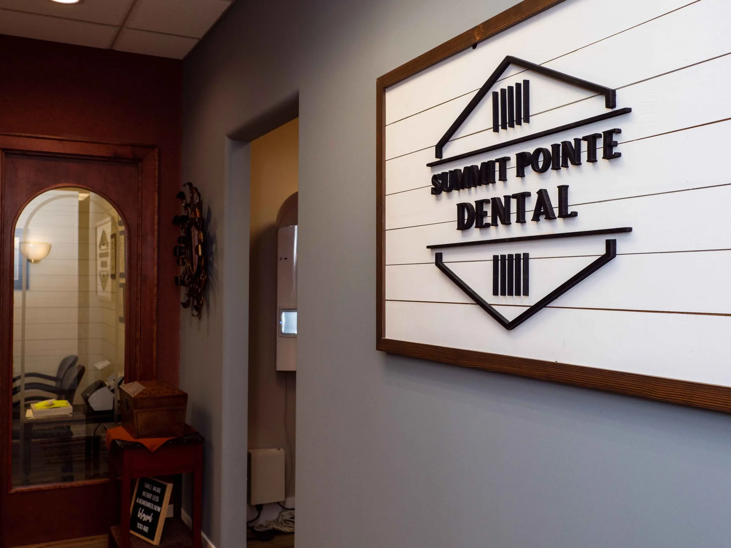 The Summit Pointe Dental sign on the shiplap wall in reception