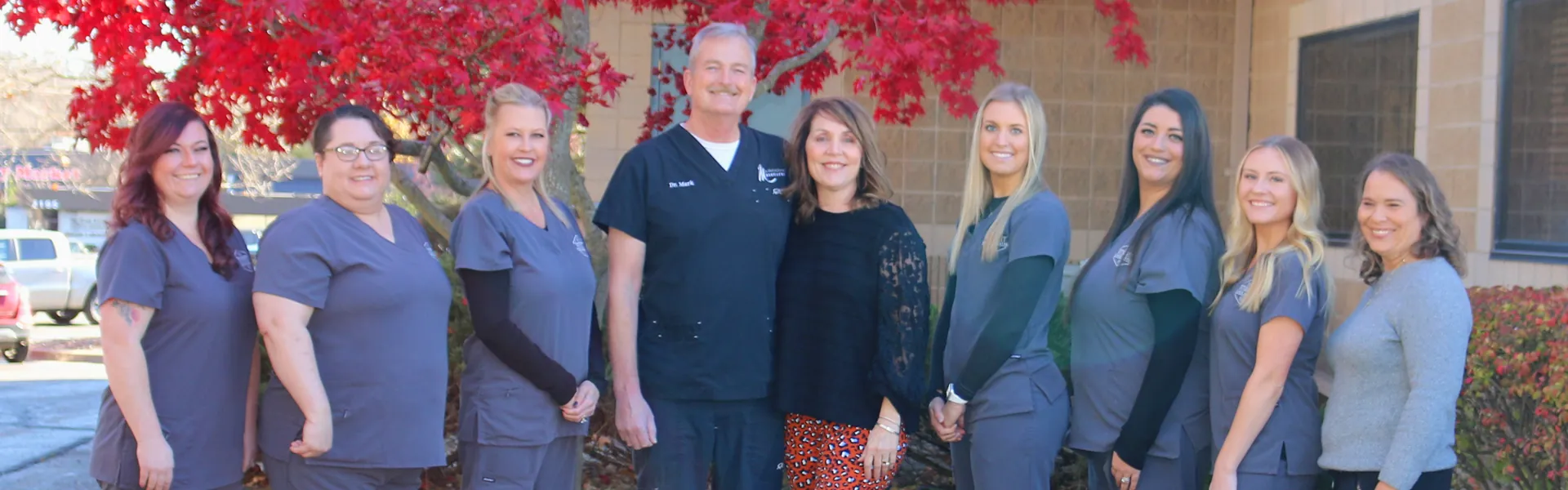 The Summit Pointe Dental team under the red maple outside the office
