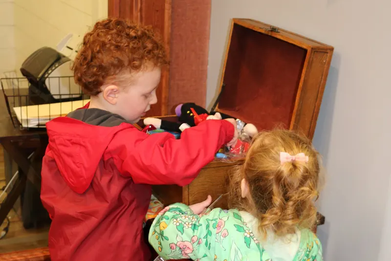Two young patients choosing a reward from the treasure chest